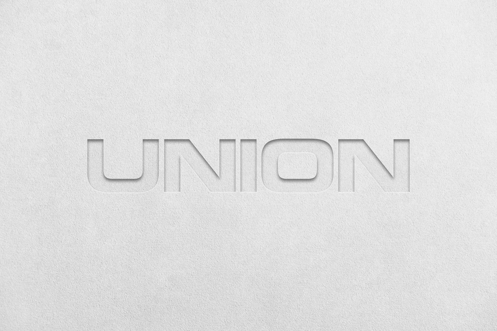 Blind-debossed Union wordmark pressed into textured uncoated cotton paper stock for the visual identity by Two Times Elliott
