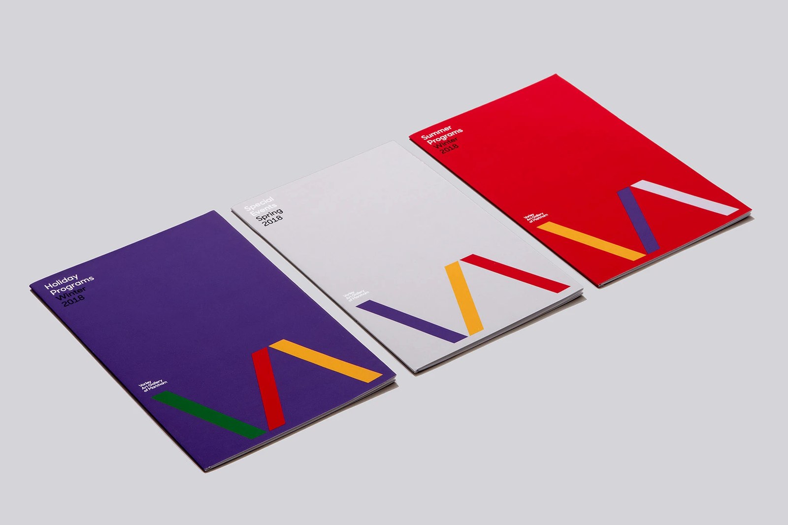 Varley Art Gallery angled collateral lineup of Holiday, Special Events, and Summer booklets with the VA logo mark and print typography