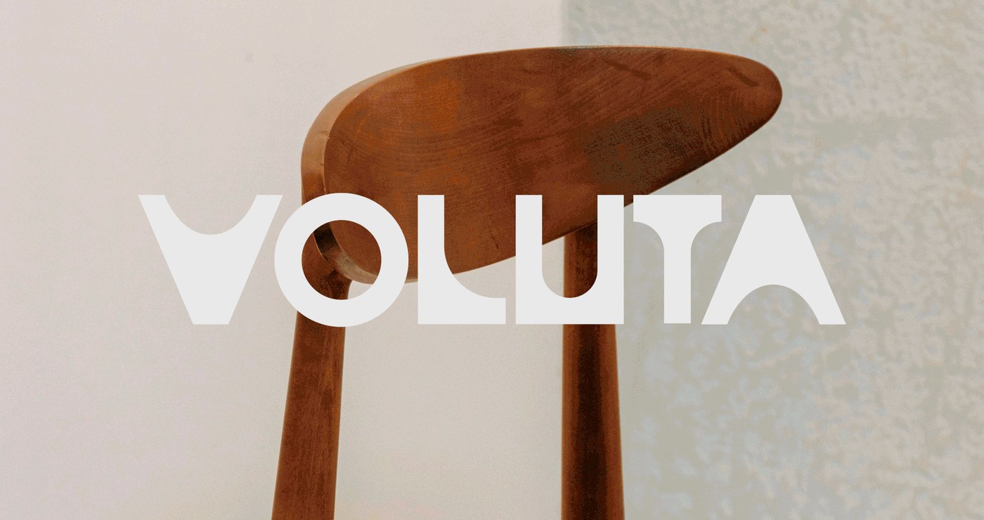 Voluta animated logotype superimposed over restored Brazilian modernist wooden chairs