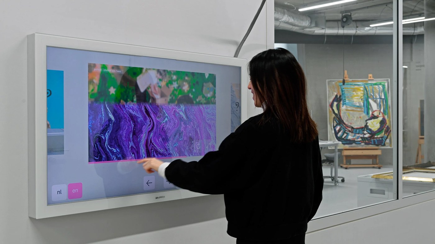 Interactive touch screen display mounted next to storage rooms in spatial design by Silo