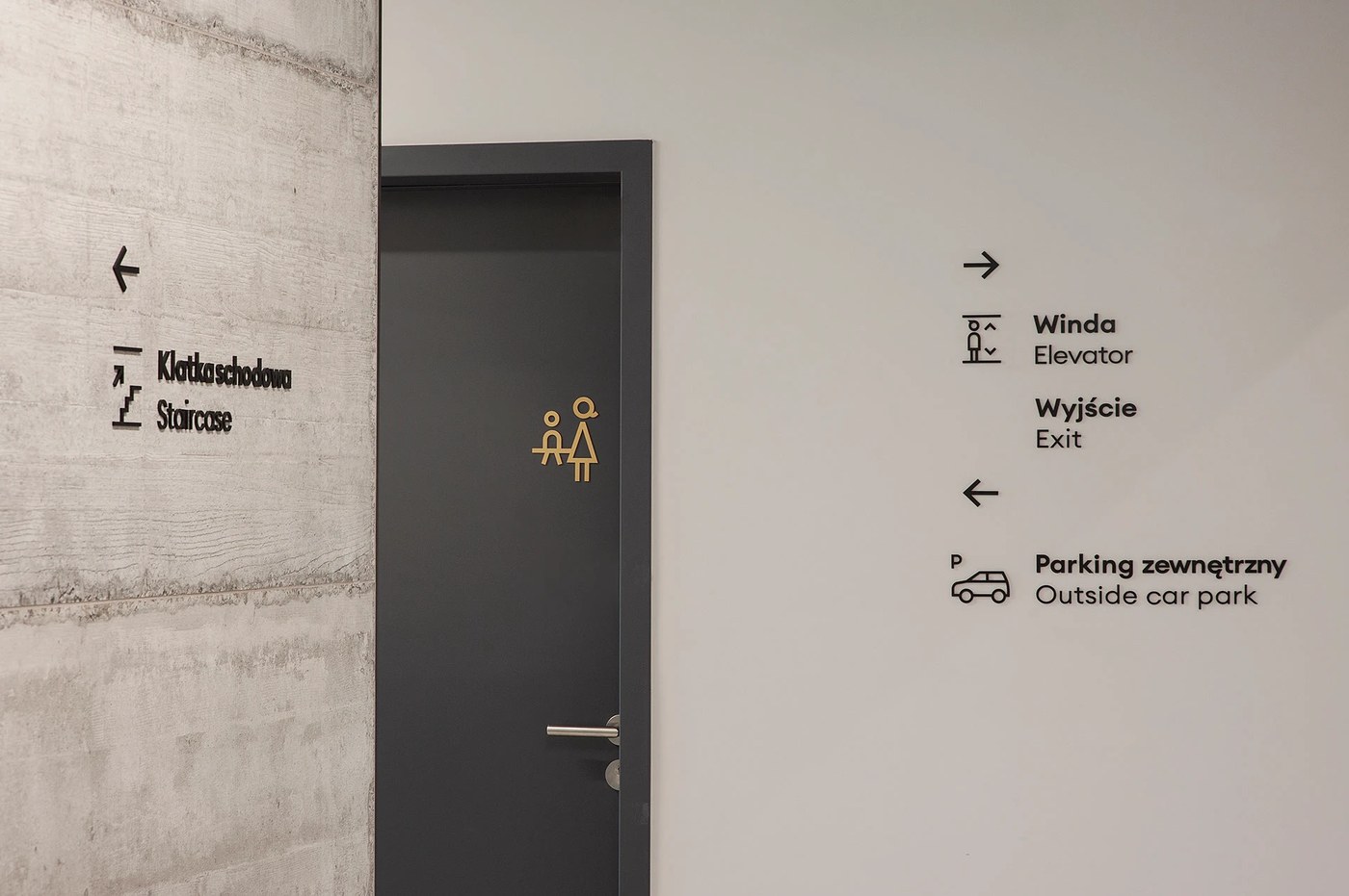 Spatial design directional signage on board-formed concrete and doorway for FORMAT by Blank Studio