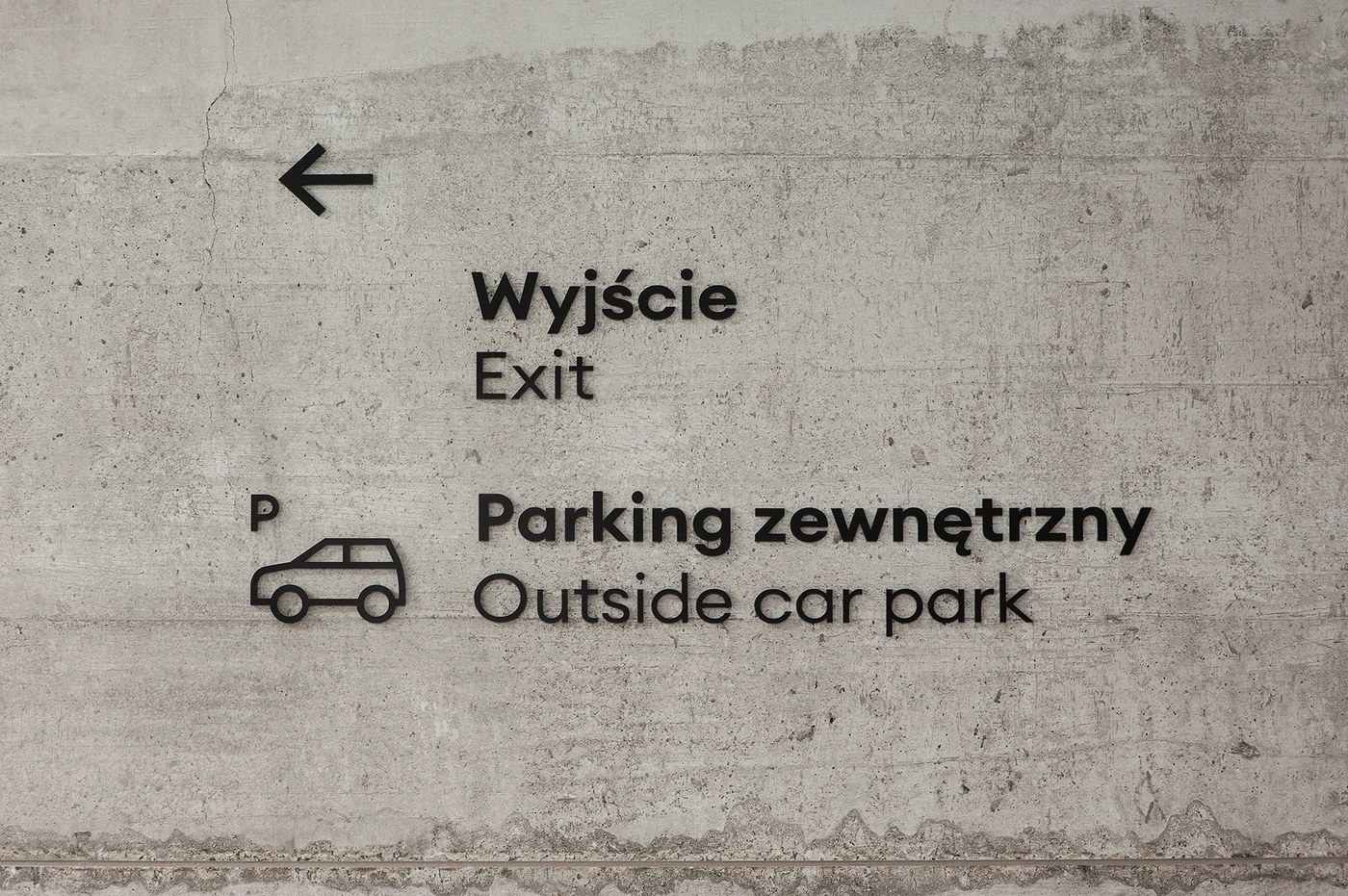 Spatial design exit and parking navigation typography on raw concrete for FORMAT by Blank Studio