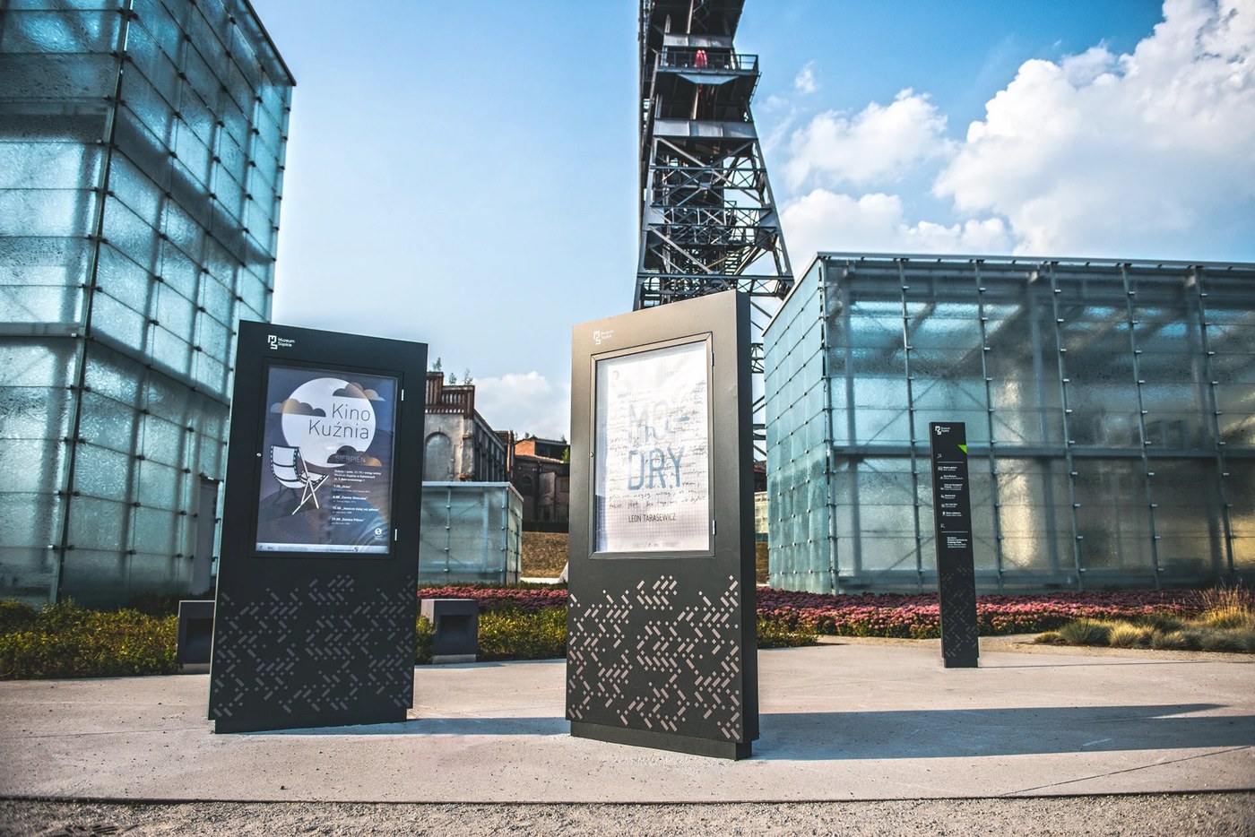 Exterior exhibition poster vitrines standing before frosted glass daylight cubes in spatial design by Aleksandra Krupa