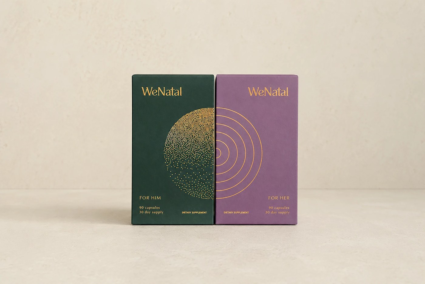 Side-by-side For Him and For Her packaging boxes forming an interlocking gold foil circle symbol and WeNatal wordmark typography in packaging design