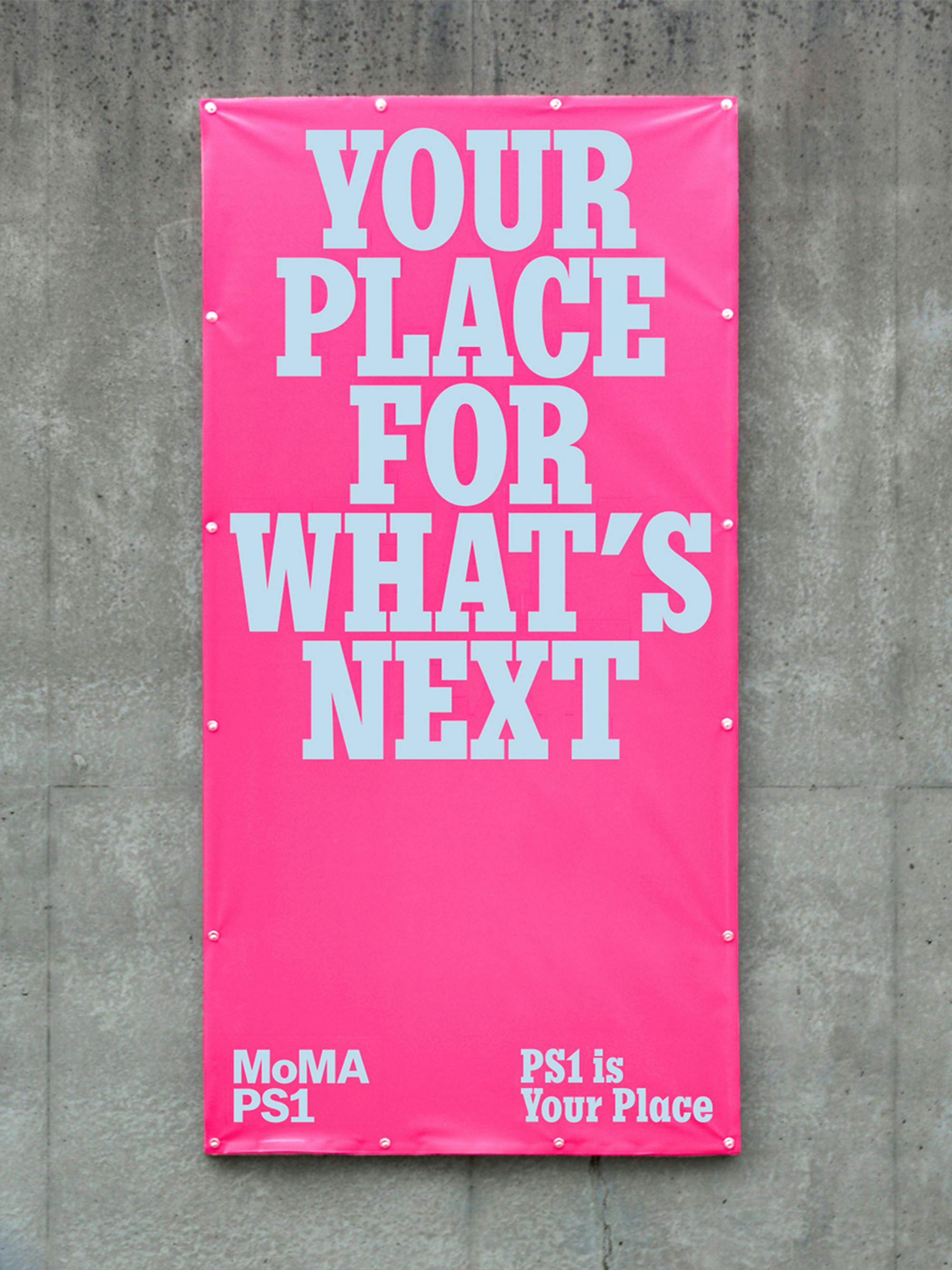 Hot pink MoMA PS1 banner reading YOUR PLACE FOR WHAT’S NEXT in PS1 Slab, mounted on concrete
