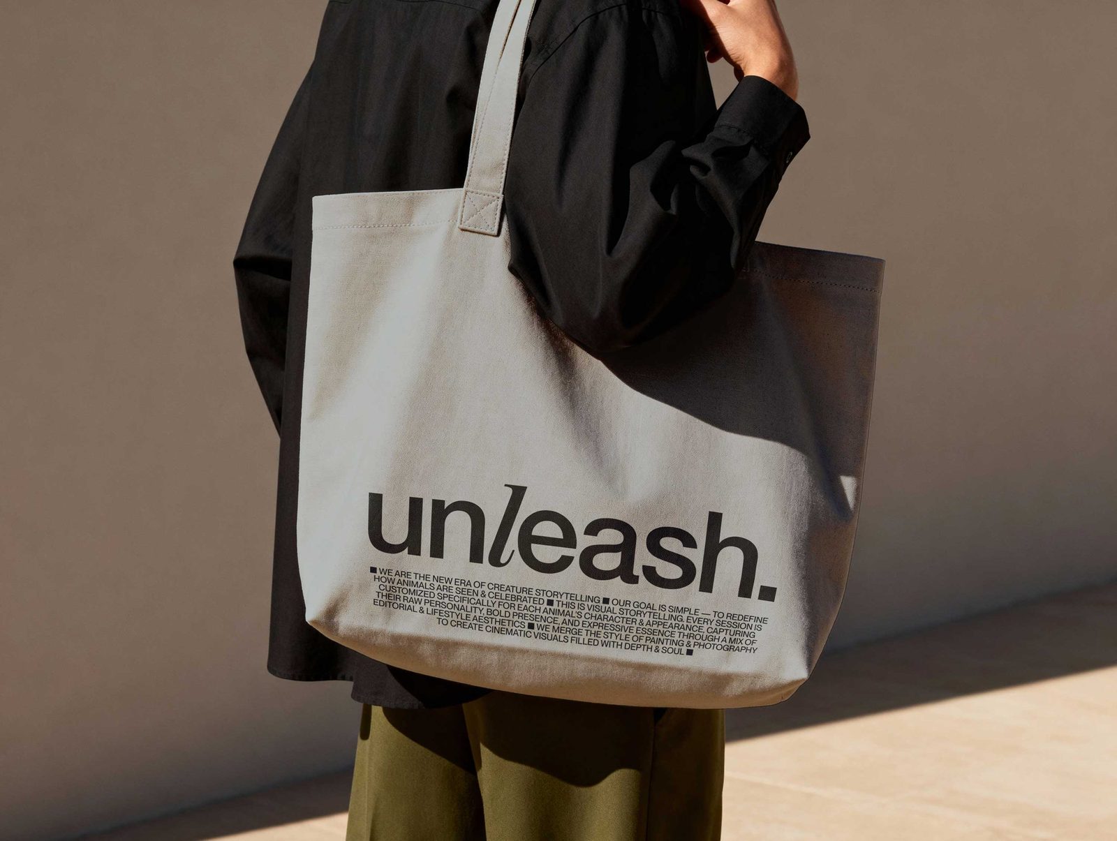 Unleash pet storytelling branding canvas tote bag printed with serif wordmark and manifesto