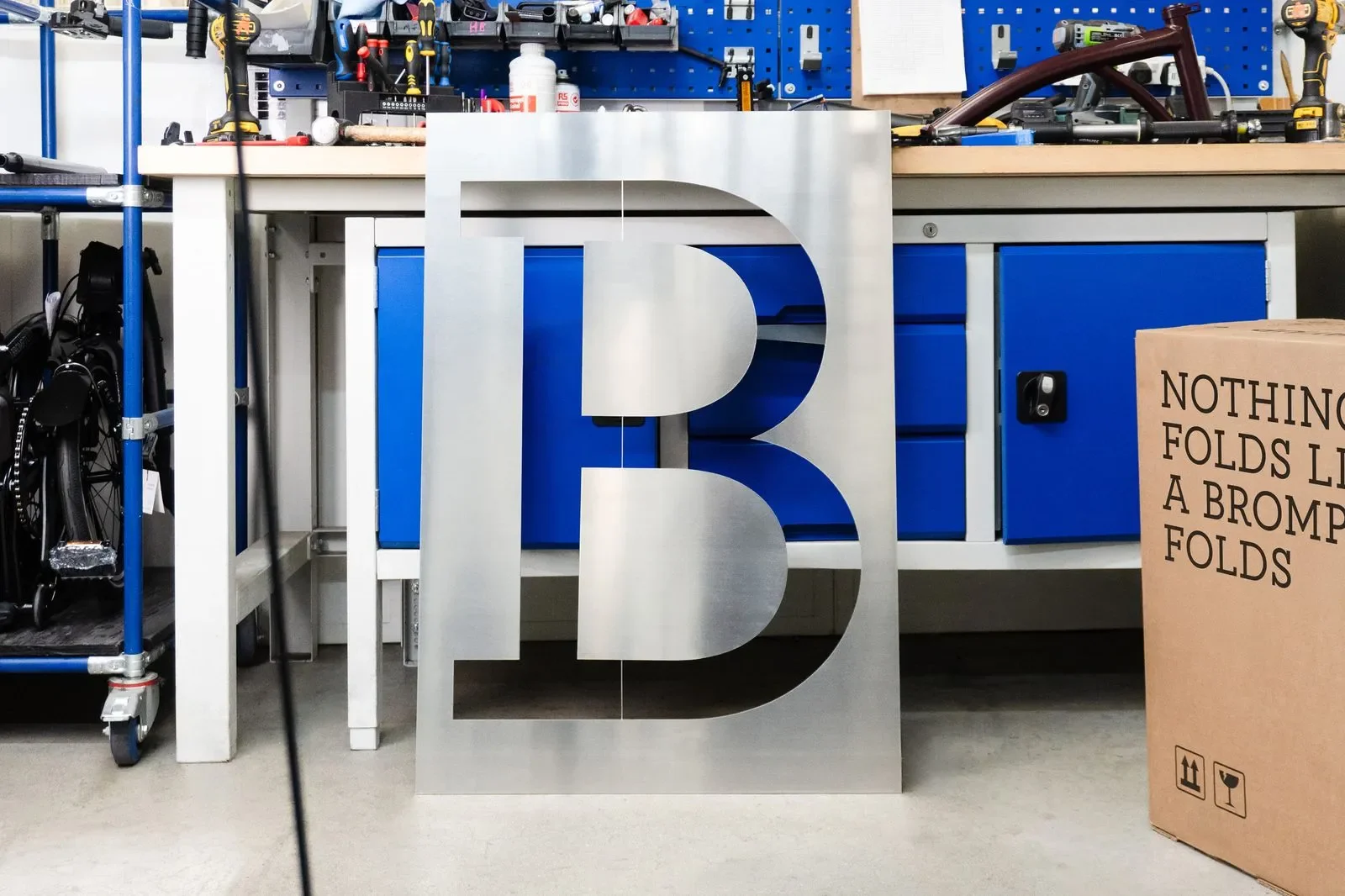 Brompton global branding brushed aluminum B stencil plate inside factory workshop