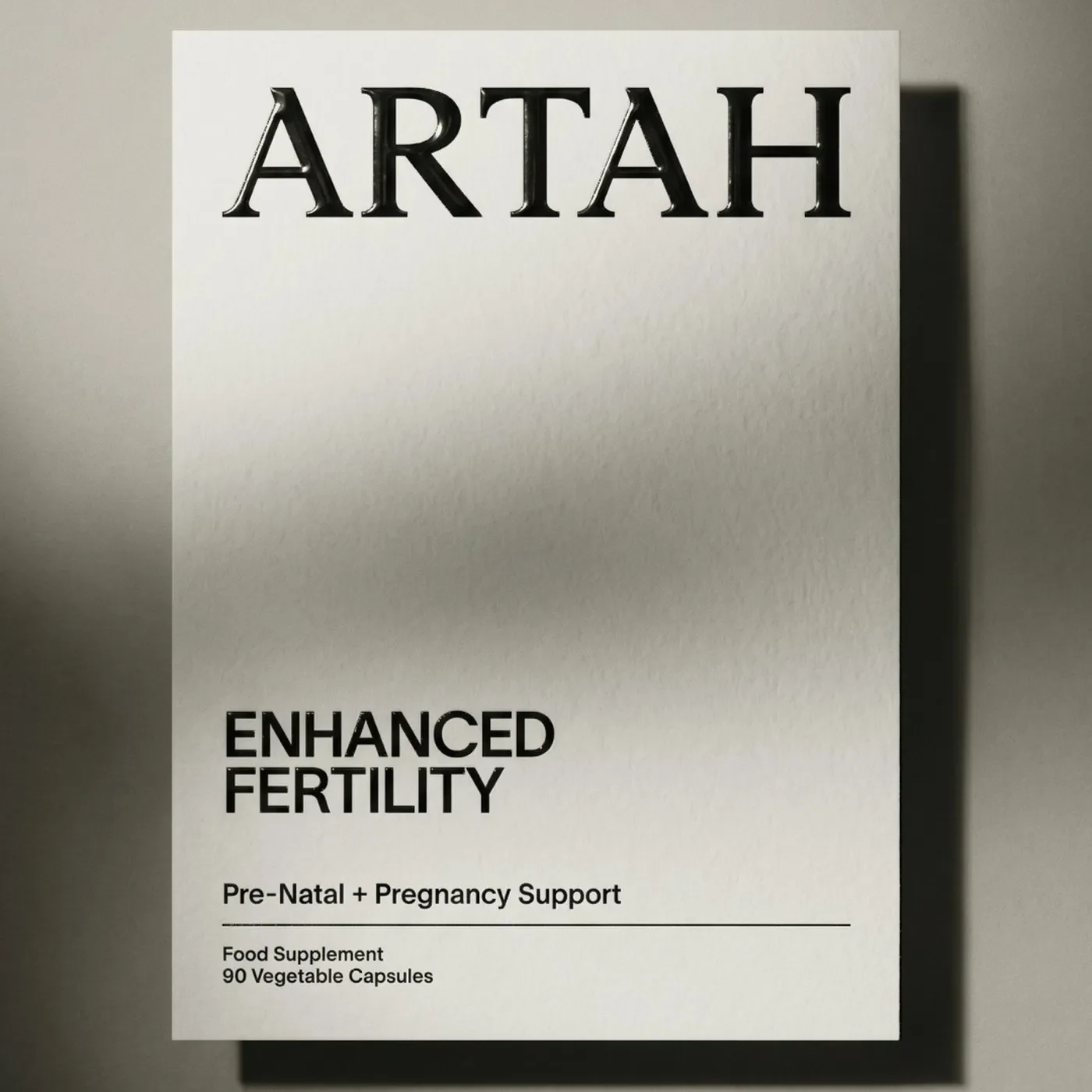 Tactile white outer carton packaging with glossy embossed Artah wordmark and clean typography in branding design