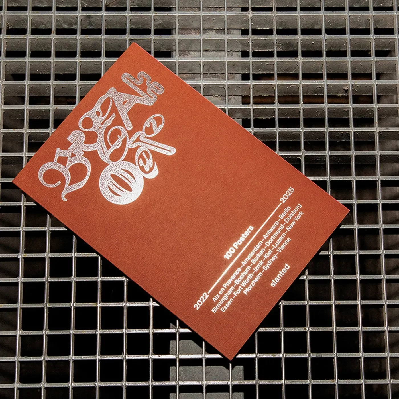 poster book design Breakout #2 cover with terracotta field and hot-foil embossed blackletter by Cihan Tamti