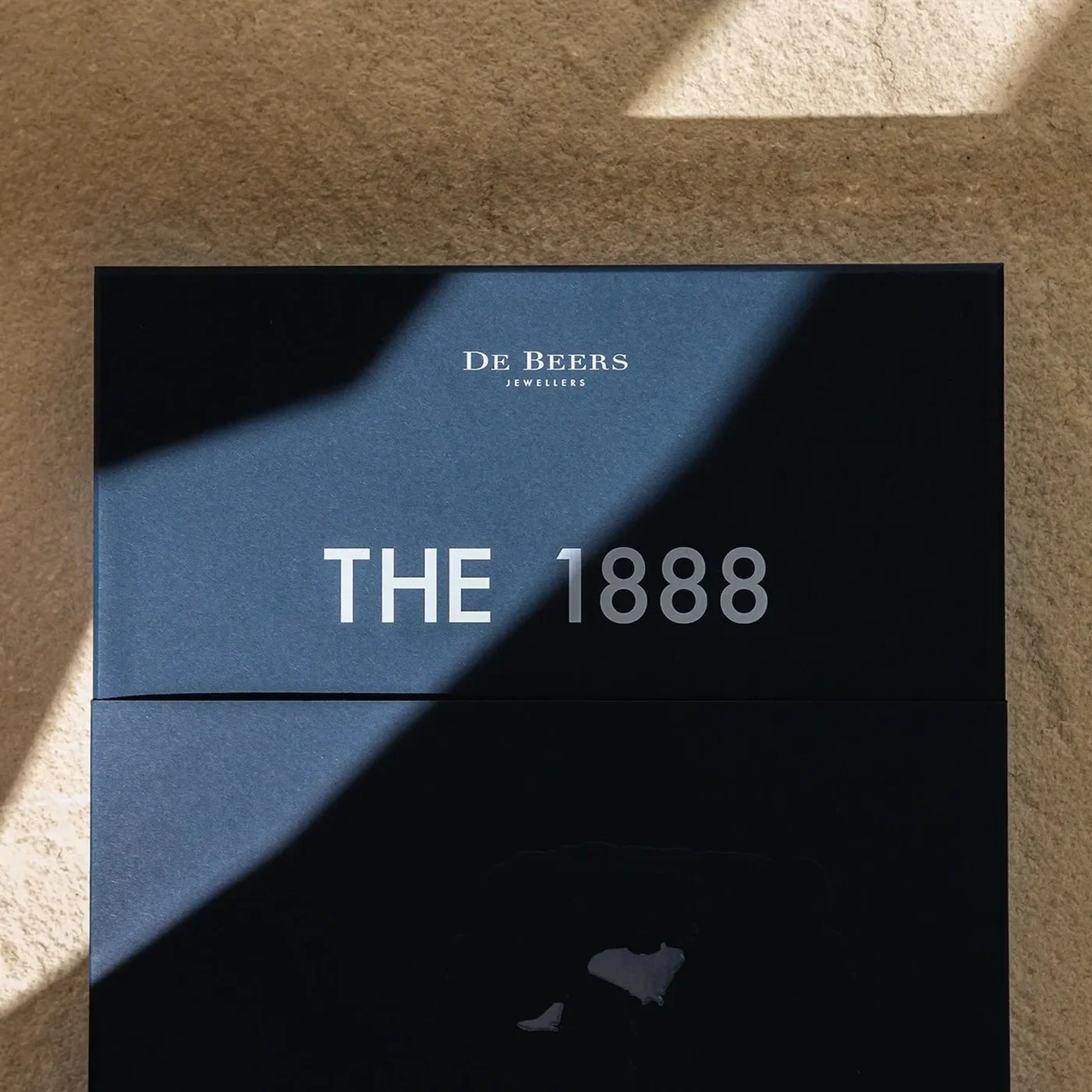 The 1888 Master Diamonds presentation box and monograph on sandstone slab — branding by Two Times Elliott