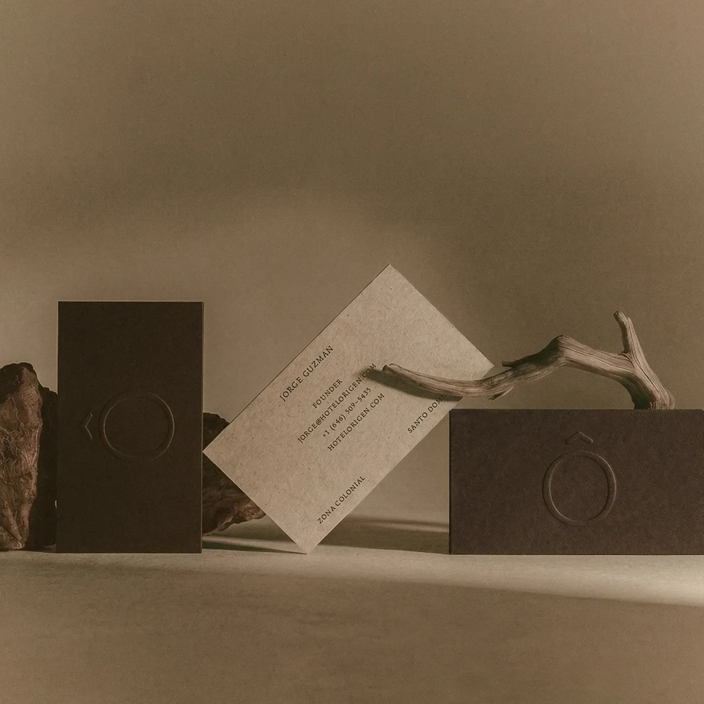 hotel rigen fugitiva .co branding business cards on a textured beige surface
