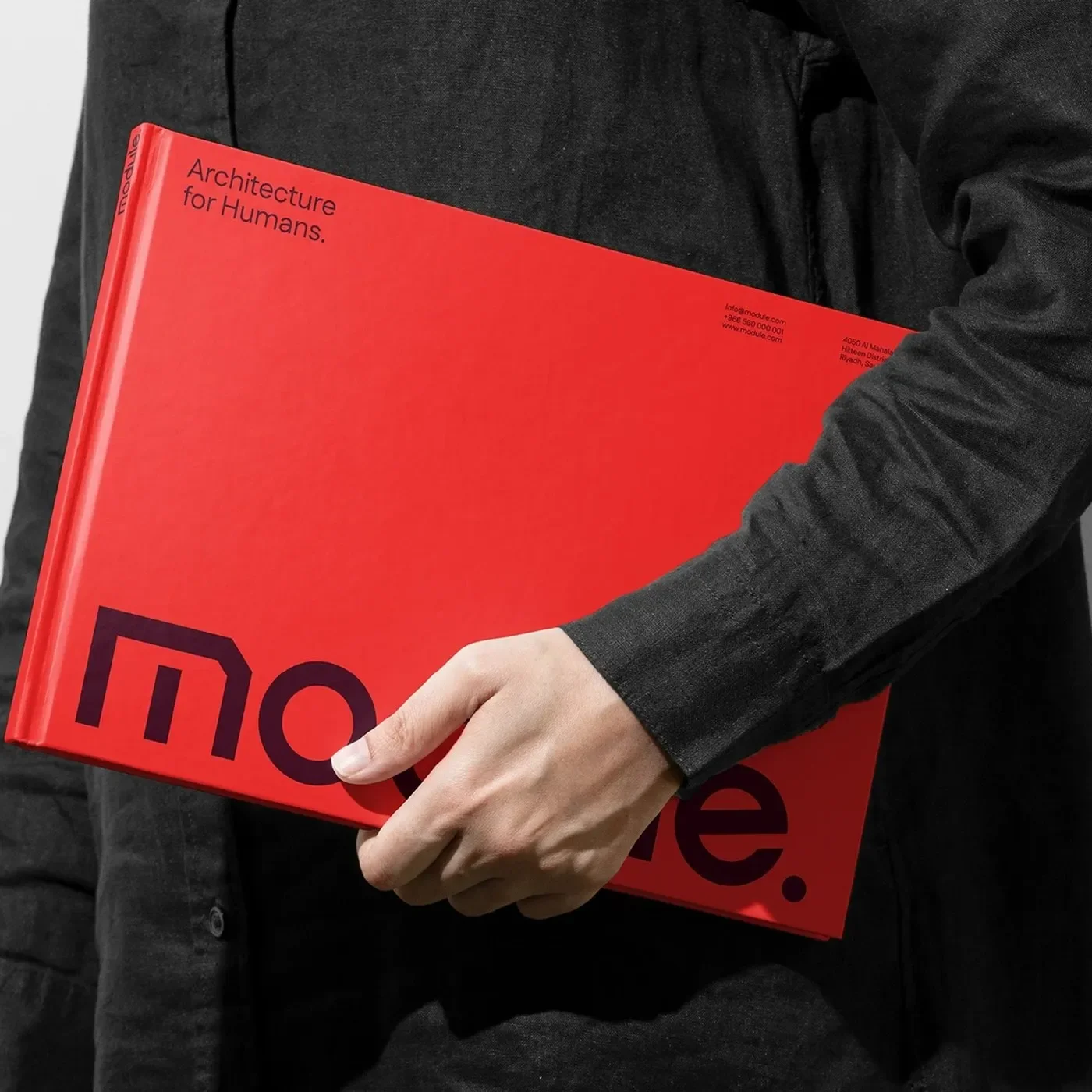 Module master brand identity presentation binder book with red hardcover and dark purple logotype