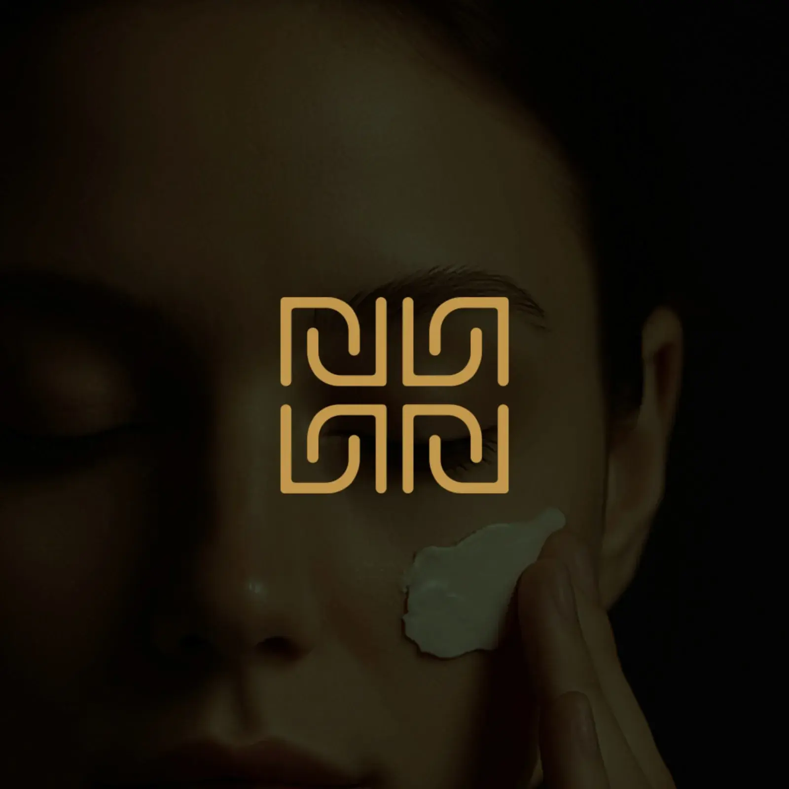 Nova Root skincare brand identity geometric monogram mark in hunter green and antique gold