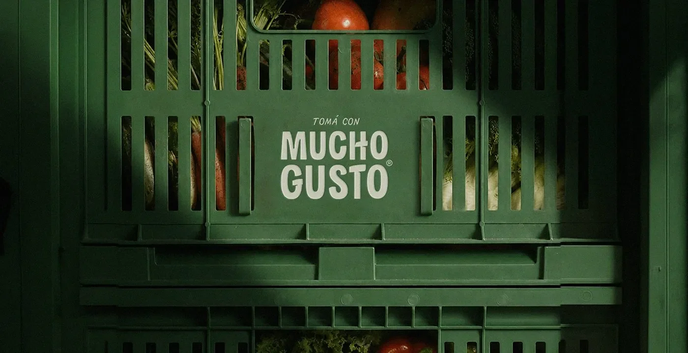 Mucho Gusto beverage branding crate with printed logo mark