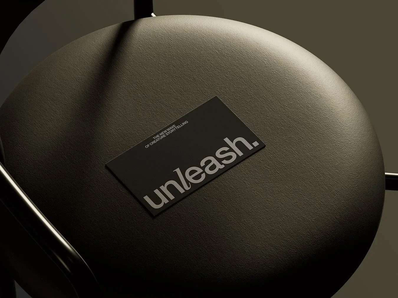 Unleash pet storytelling branding black foil-stamped business card on leather cushion by Stud Creative House