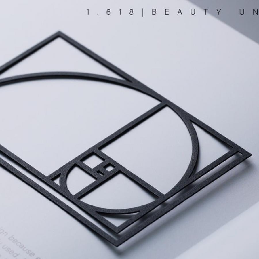 1.618 Golden Ratio Paperclip product design on open notebook