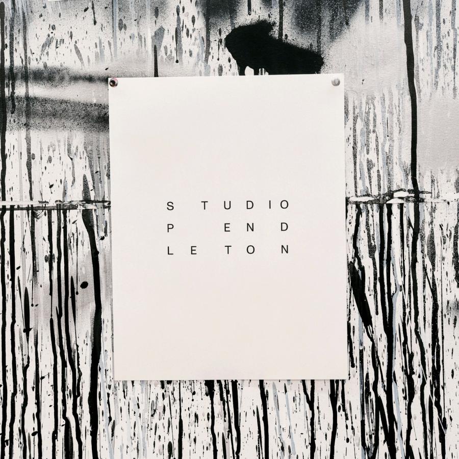 Black Studio Pendleton manifesto poster with typographic principles pinned beside spray-painted artwork by SAVVY STUDIO