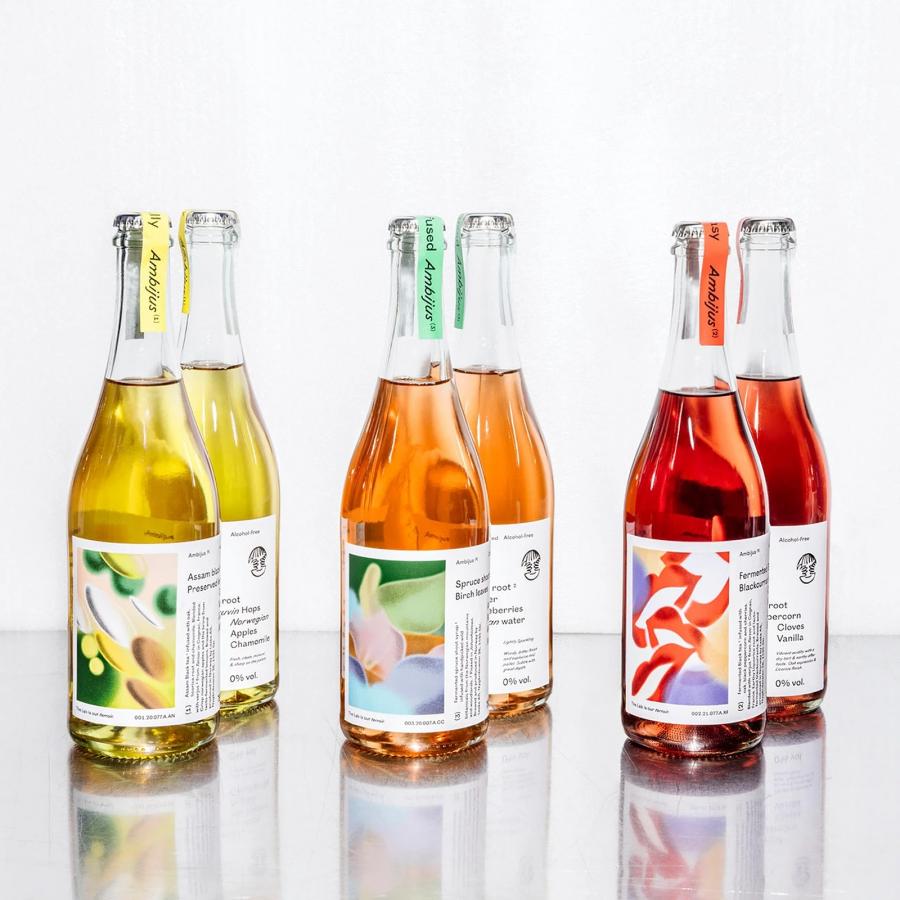 Ambijus full packaging design system overview showing wordmark typography, color palette neck seals, and illustrated bottle labels — packaging design by OlssønBarbieri