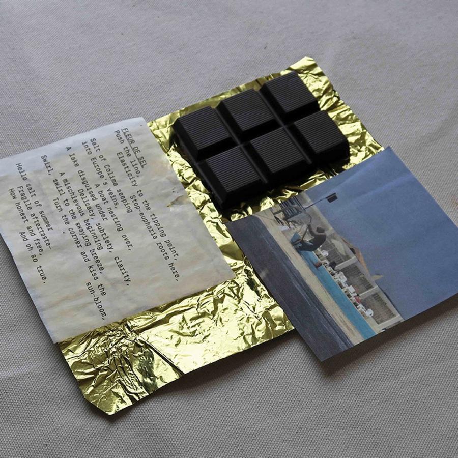 Casa Bosques chocolate packaging design showing poetry slips and chocolate bar in glassine sleeve by SAVVY STUDIO