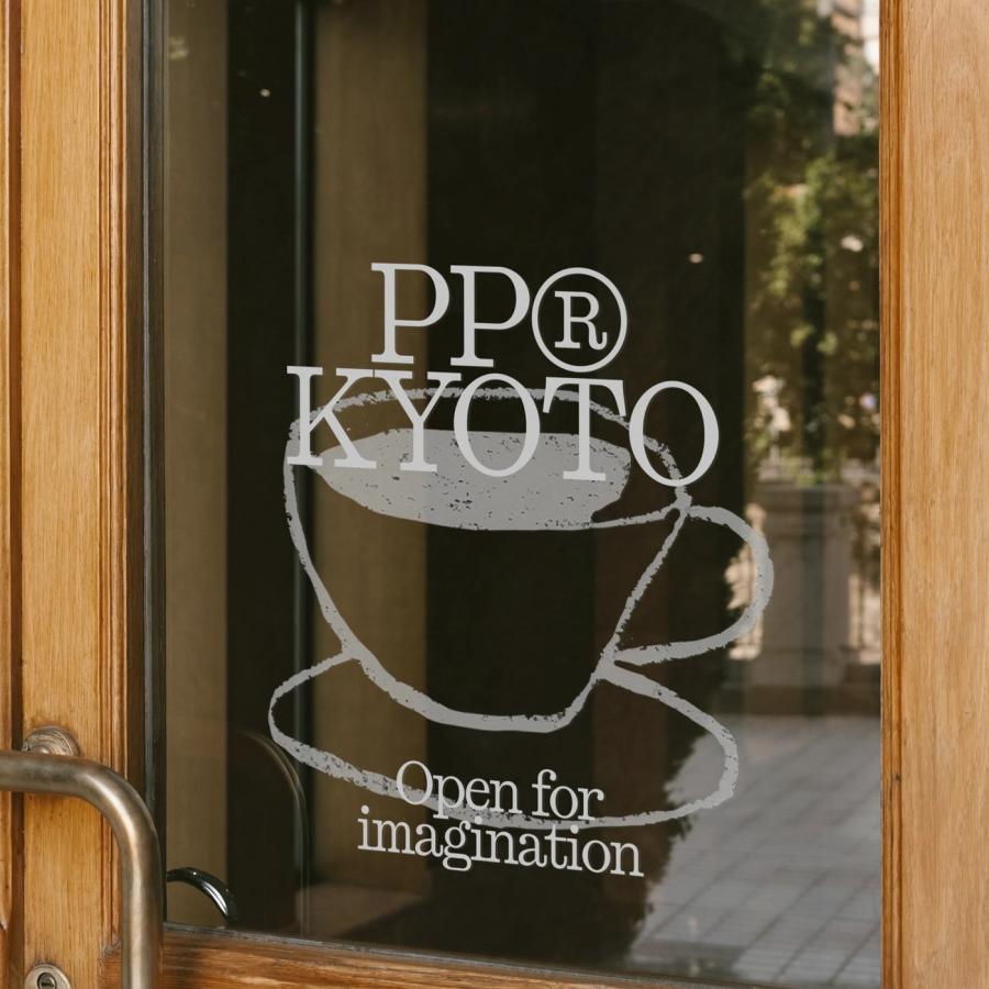 PP Kyoto logo wordmark decal on wooden glass entrance door demonstrating typeface design