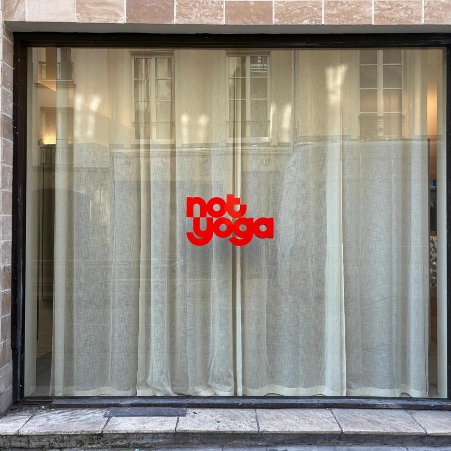 visual identity brand overview with dimensional red logo and typography on Paris storefront window