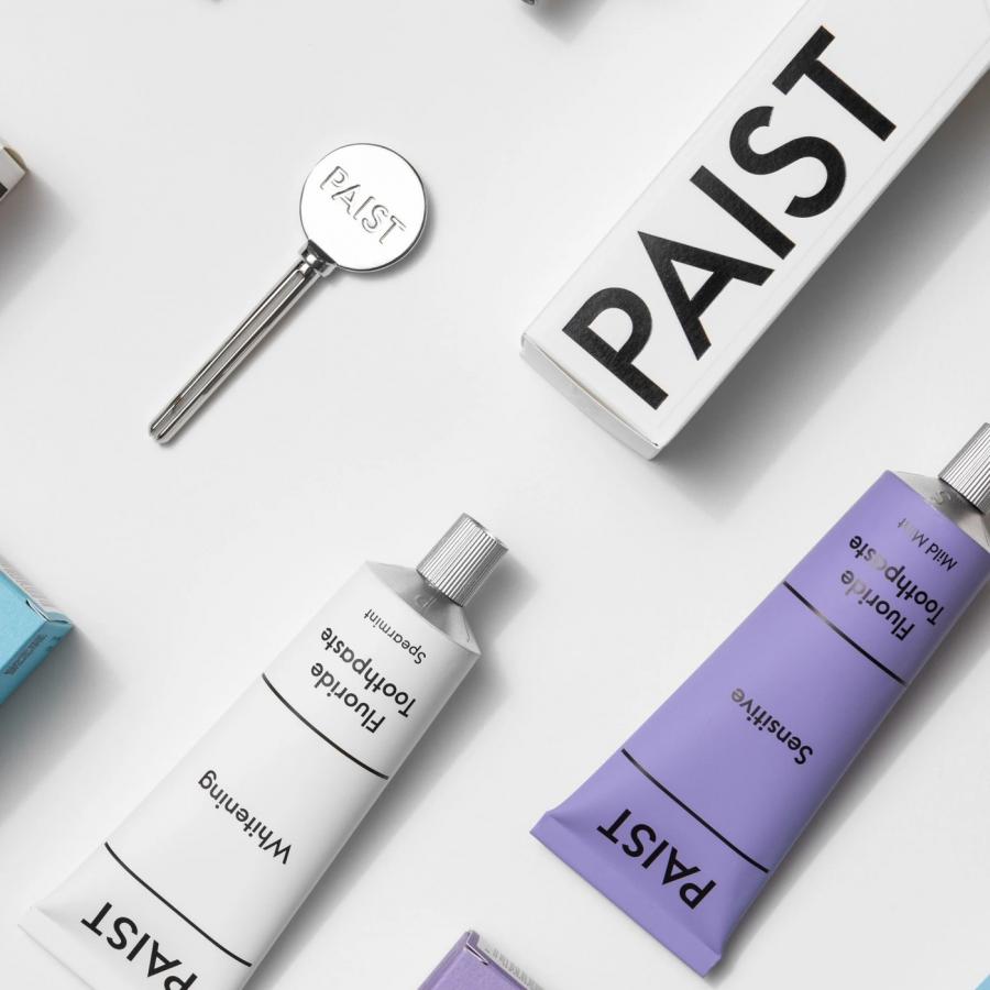 Paist brand identity master system board and packaging flat lay with embossed logo key and tubes