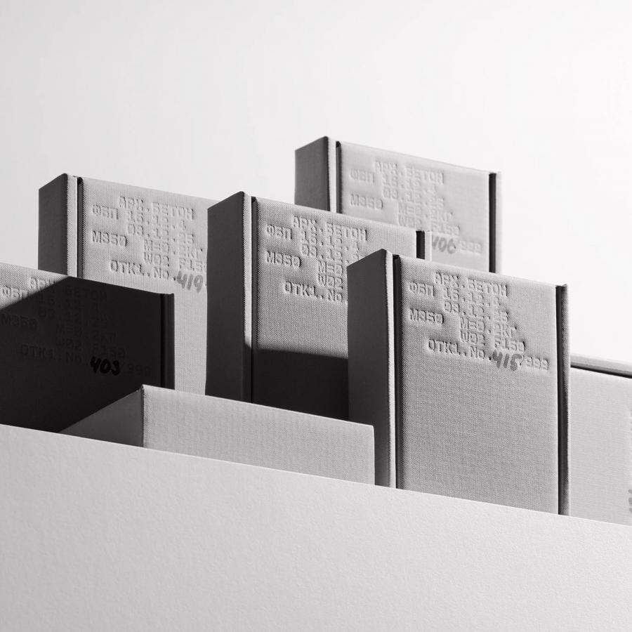 Rigid concrete grey book boxes showcasing industrial packaging design and stamped technical specifications