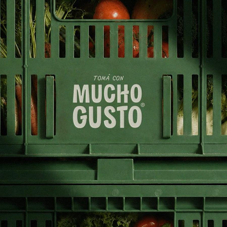 Mucho Gusto beverage branding crate with printed logo mark